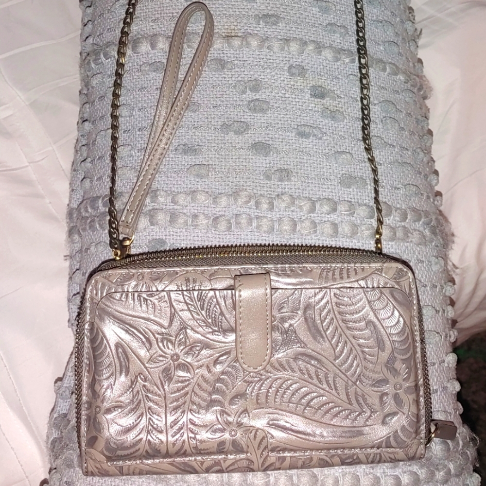 gray wristlet with chain and leather strap to use as crossbody style.